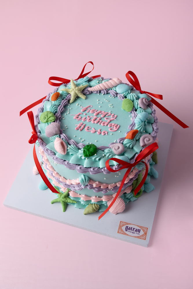 Custom mermaid theme cake with colorful decorations and ocean-inspired elements for birthday celebrations