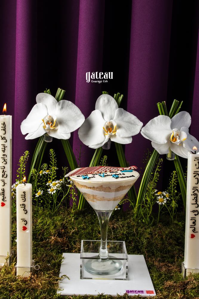 Father's Day dessert goblet layered cake in a clear glass with decorative white orchids by Gateau Gourmet Cafe