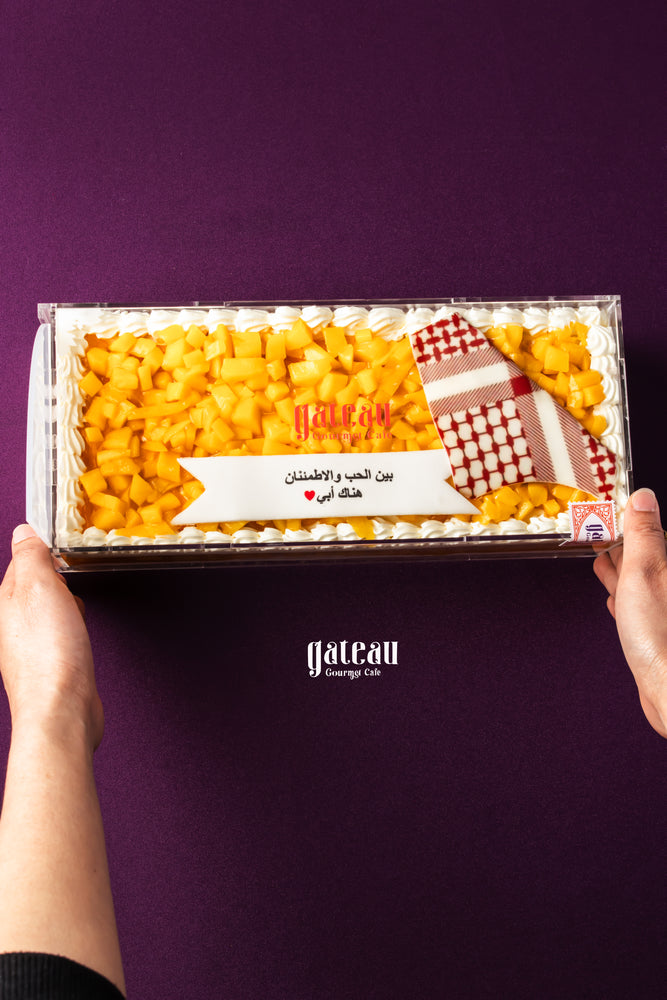 Gateau Gourmet Cafe mango fruit Father's Day cake delivery in a rectangular box held by two hands