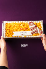 Gateau Gourmet Cafe mango fruit Father's Day cake delivery in a rectangular box held by two hands