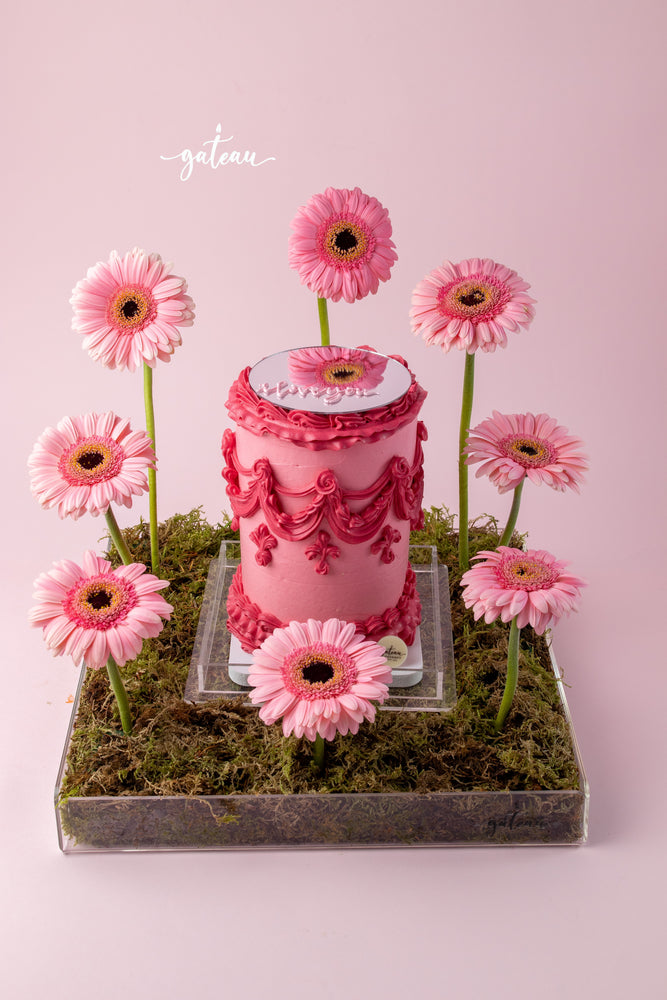All Pink Victorian Cake with Mirror and Flower Arrangement on a decorative base with pink flowers