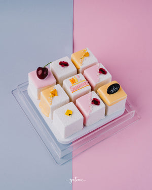 Gateau Gourmet Cafe artisan mini cakes delivery set with colorful decorated small square cakes on clear tray
