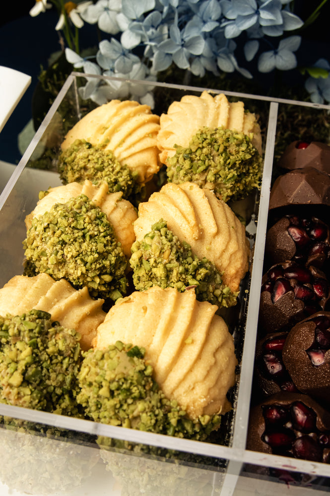 Assorted Arabic treats with arrangement featuring nutty sweets and chocolate delights from Gateau Gourmet Cafe