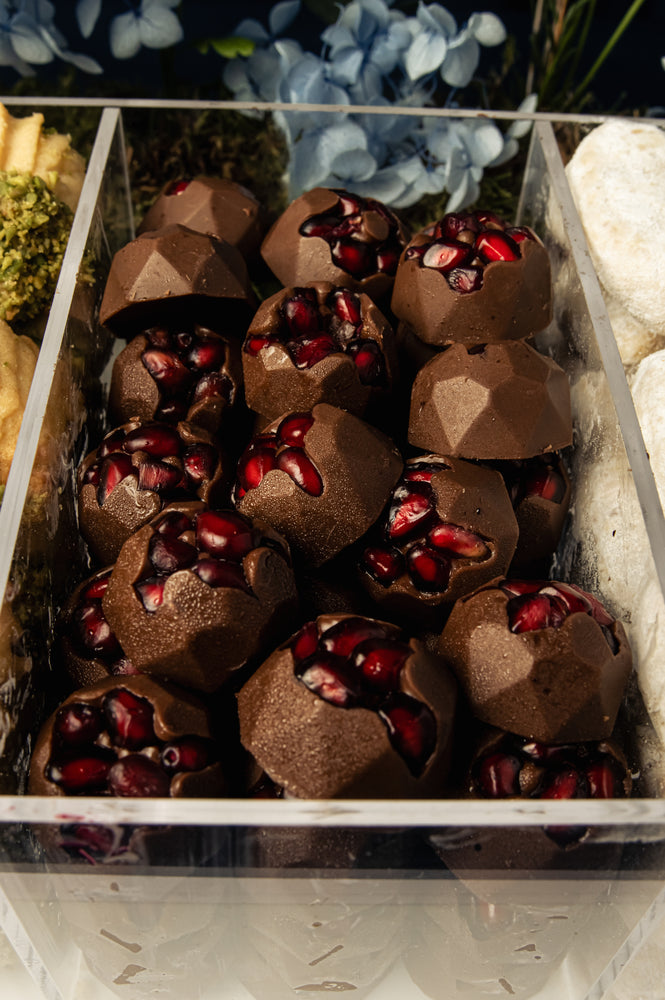 Luxurious assorted-arabic-treats-w-arrangement featuring chocolate treats with pomegranate seeds