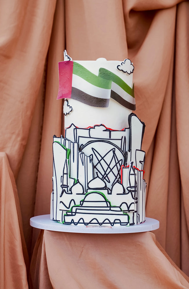 AUH skyline cake featuring a colorful design with iconic city landmarks and decorative elements