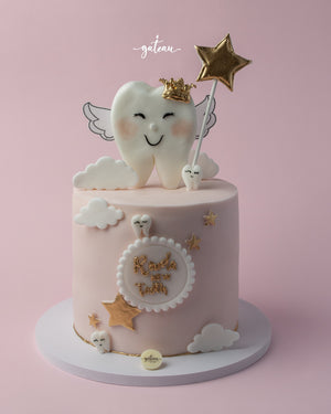 Baby tooth celebration cake featuring a cute tooth design with wings and a golden star on top