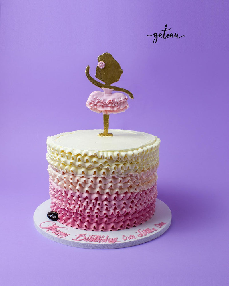 Ballerina themed cake with pink ruffles and a dancer topper, perfect for celebrations