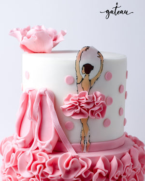 Ballet birthday cake with pink ruffles, ballet slippers, and a ballerina figure for a festive celebration