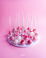 Gateau Gourmet Cafe pink and white cake pops arranged on a white round tray for barbie cake pops delivery