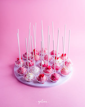 Gateau Gourmet Cafe pink and white cake pops arranged on a white round tray for barbie cake pops delivery