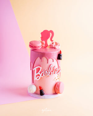 Pink Barbie theme birthday cake with macarons and lipstick decorations by Gateau Gourmet Cafe