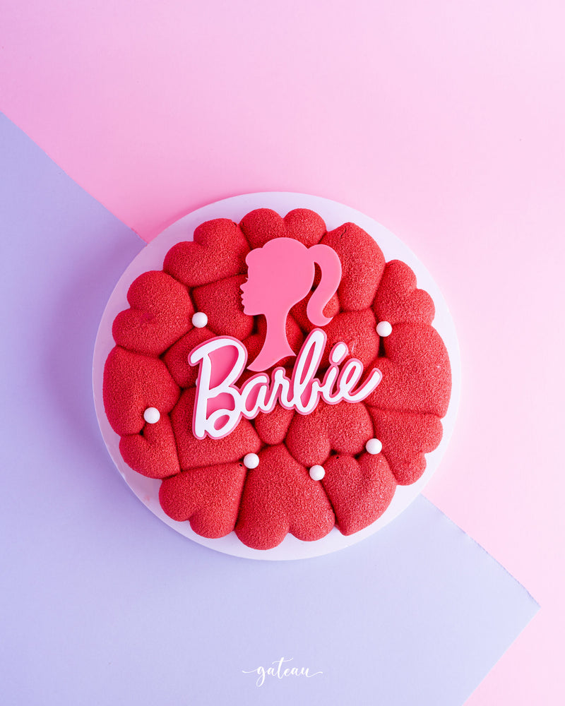 Barbie theme cake for birthdays with red heart shapes and pink Barbie silhouette decoration
