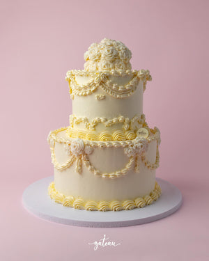 Bride to Be custom cake by Gateau Gourmet Cafe three-tier white cake with elegant floral and swirl decorations