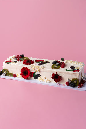 Delicious fruity cake decorated with fresh berries and edible flowers, perfect to buy fruity cakes