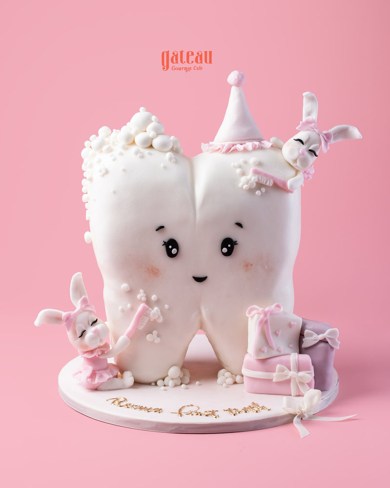 Baby’s First Tooth Celebration Cake featuring a tooth design with cute bunnies and pastel accents