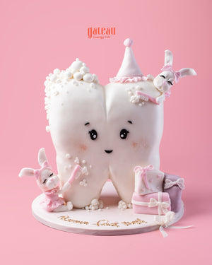 Baby’s First Tooth Celebration Cake featuring a tooth design with cute bunnies and pastel accents