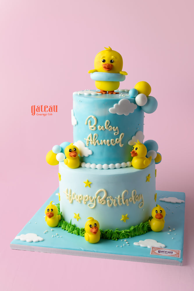 Duck themed birthday cake from Gateau Gourmet Cafe with cute duck decorations and pastel colors
