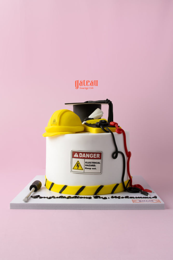Electrical engineering cake designed with safety gear and themed decorations for engineering celebrations