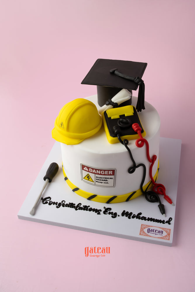 Electrical engineering cake featuring a graduation cap, hard hat, and tools for engineering celebrations
