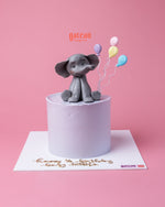 Elephant themed cake from Gateau Gourmet Cafe with cute gray elephant figure and pastel balloons