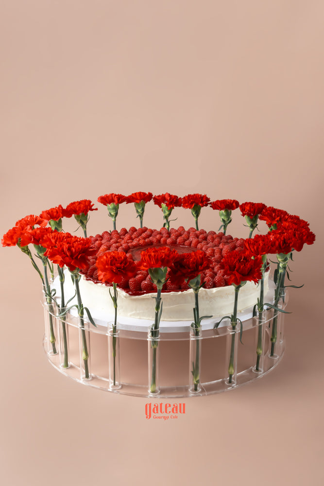 Gateau Gourmet Cafe overloaded raspberry cake decorated with fresh red flowers for an elegant presentation