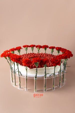 Gateau Gourmet Cafe overloaded raspberry cake decorated with fresh red flowers for an elegant presentation