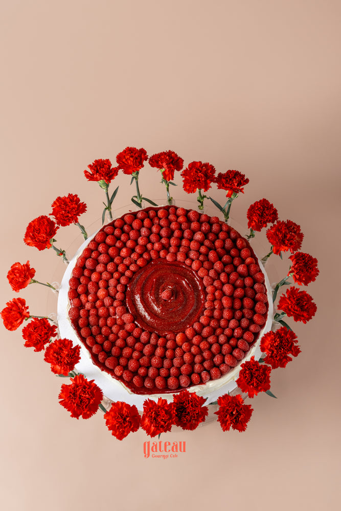 Overloaded raspberry cake from Gateau Gourmet Cafe, beautifully decorated with fresh raspberries and red flowers