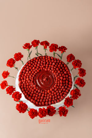 Overloaded raspberry cake from Gateau Gourmet Cafe, beautifully decorated with fresh raspberries and red flowers