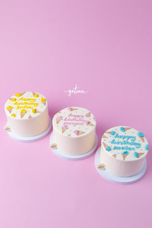 Three colorful ice cream pastel Birthday cakes with festive designs by Gateau Gourmet Cafe
