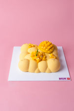 Mango Vanilla Mousse Cake from Gateau Gourmet Cafe with a smooth, vibrant yellow appearance and mango toppings