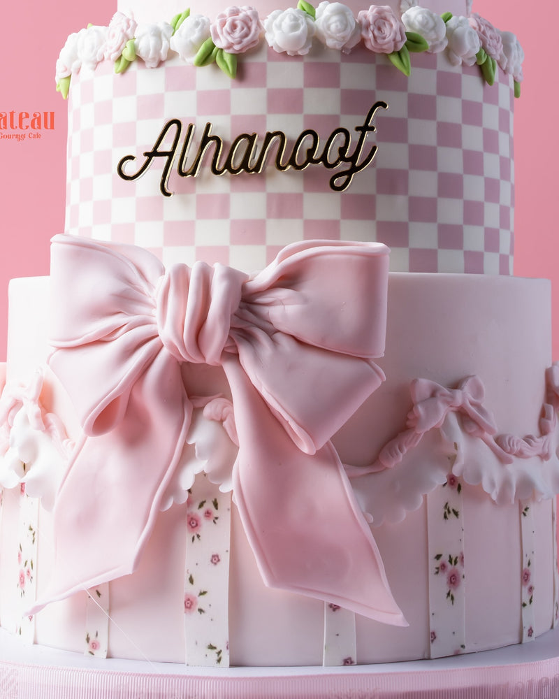 Melody-character-cake from Gateau Gourmet Cafe featuring pink layers and floral decorations