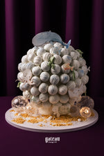 Whale truffle tower decorated with sea creatures and edible pearls in a whimsical design