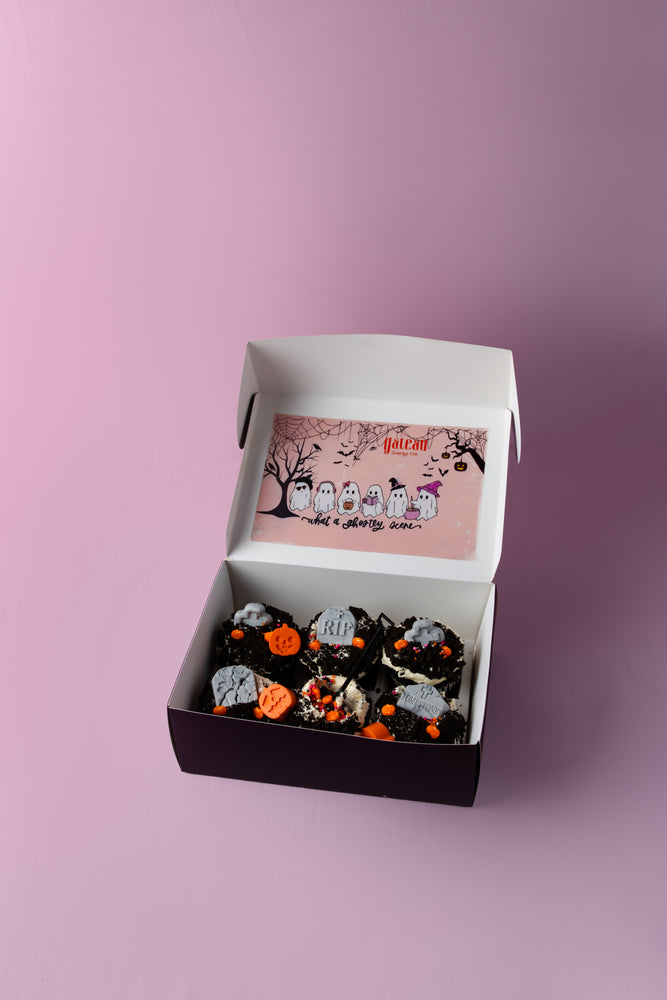 Box of creepin it real cupcakes with Halloween decorations from Gateau Gourmet Cafe