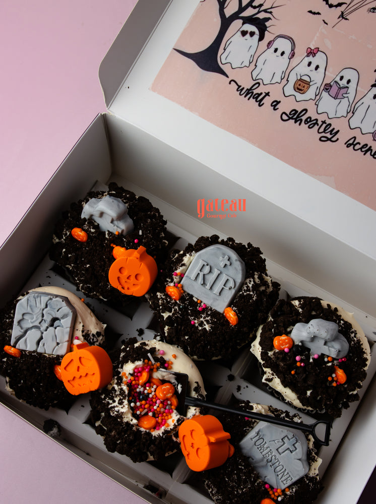 Halloween creepin it real cupcake decorated with spooky gravestones and pumpkins in a festive box