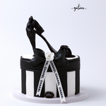 Channel shoe cake on box designed with elegant black heels and white ribbon for special occasions