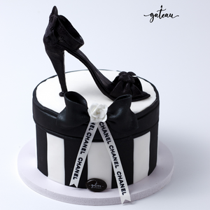 Elegant channel-shoe-cake-on-box featuring a high-heel design and black bow for special celebrations