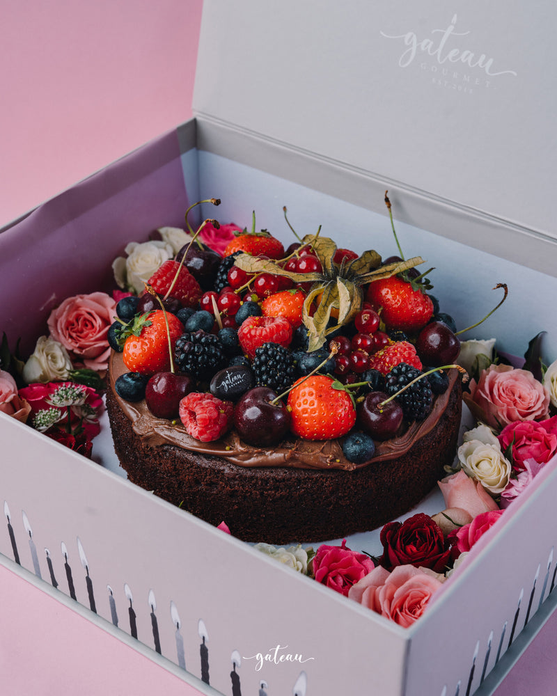 Gateau Gourmet Cafe chocolate fudge with mixed berries cake decorated with strawberries cherries and roses in a gift box