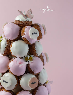 Gateau Gourmet Cafe elegant choux tower dessert with pink and white icing decorated with butterflies and flowers