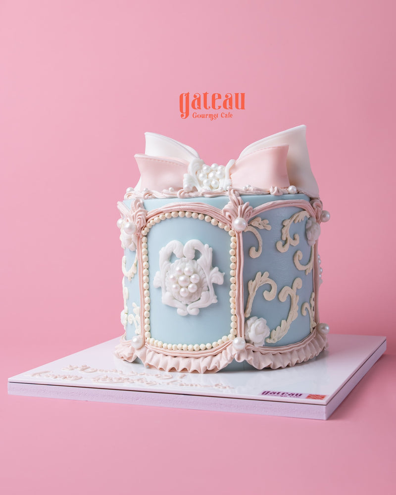 Circus dream carousel cake with elegant pastel blue design and intricate floral decorations from Gateau Gourmet Cafe