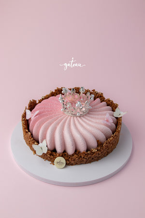 Crunchy Pink Mousse Cake with a textured exterior and decorative crown and butterflies