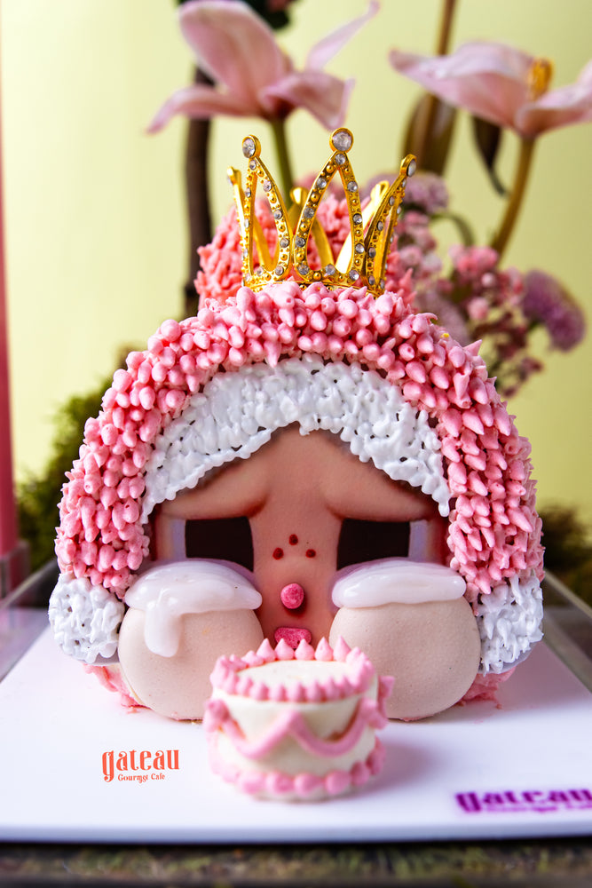 CRYBABY cake limited edition by Gateau Gourmet Cafe decorated with pink and white frosting and a gold crown