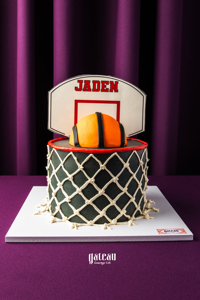 Gateau Gourmet custom basketball birthday cake with basketball and net design topped with personalized name Jaden