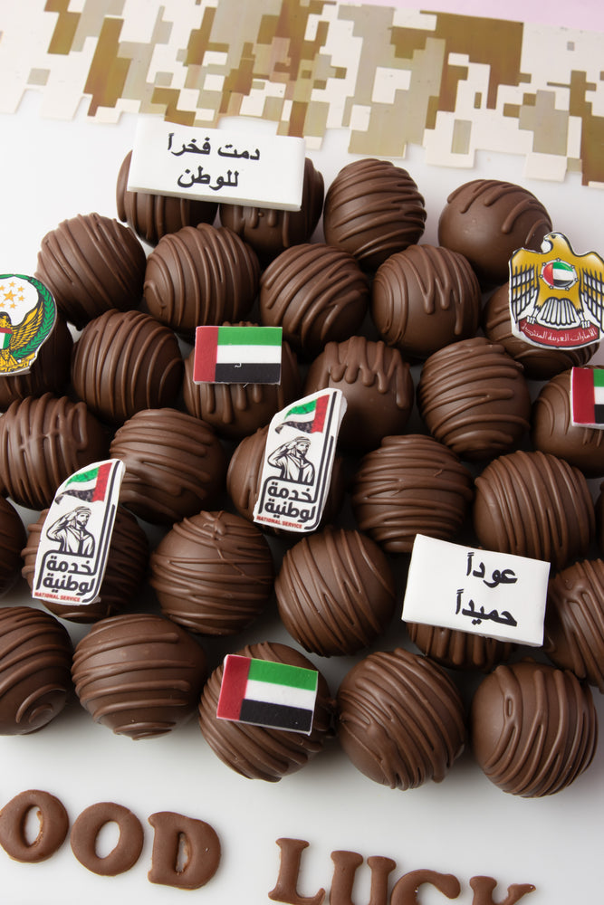 Custom chocolate truffle board with decorative truffles featuring UAE flags and symbols
