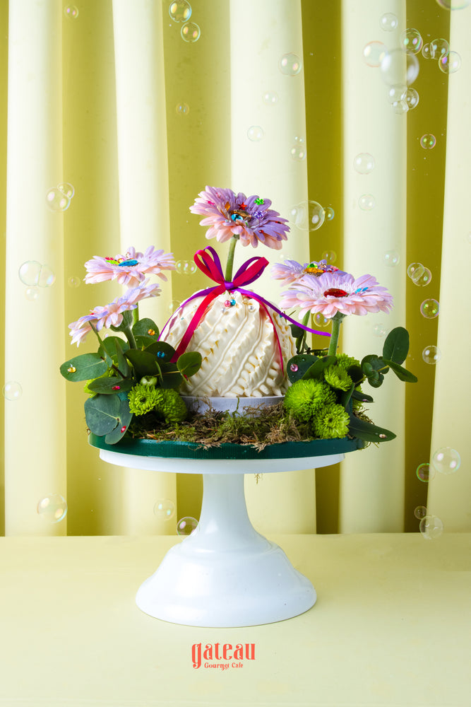Gateau Gourmet Cafe custom floral cake for summer with pink flowers and green foliage on white cake stand