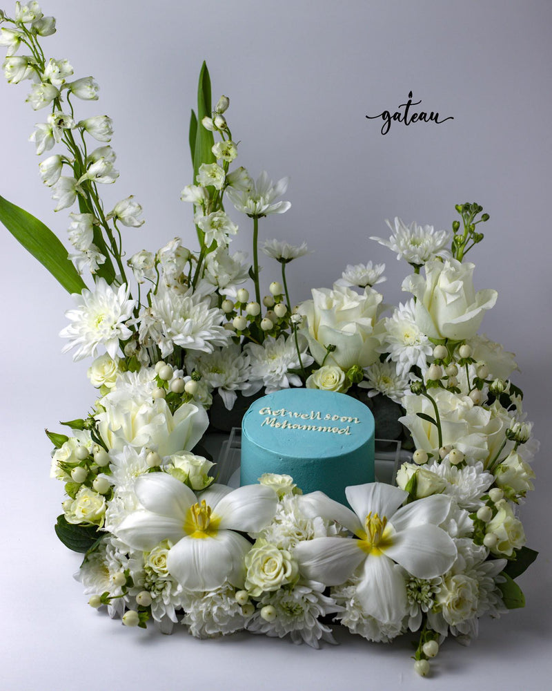 Custom get well cake by Gateau Gourmet Cafe with blue icing surrounded by white flowers
