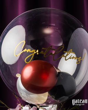 Custom graduation balloon bouquet featuring elegant colors and congratulatory message for celebrations