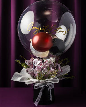 Custom graduation balloon bouquet with festive colors and elegant floral arrangement for celebration