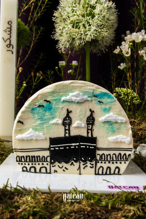 Gateau Gourmet Cafe custom Hajj themed cake with detailed illustration of Kaaba and blue sky