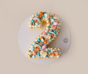 Colorful custom number cake shaped as number 2 with pastel decorations from Gateau Gourmet Cafe