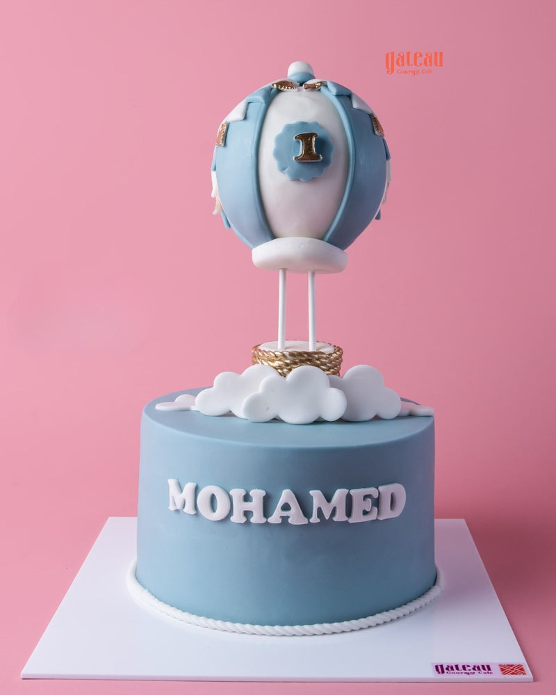 Customized air balloon themed cake by Gateau Gourmet Cafe with a blue design and gold accents